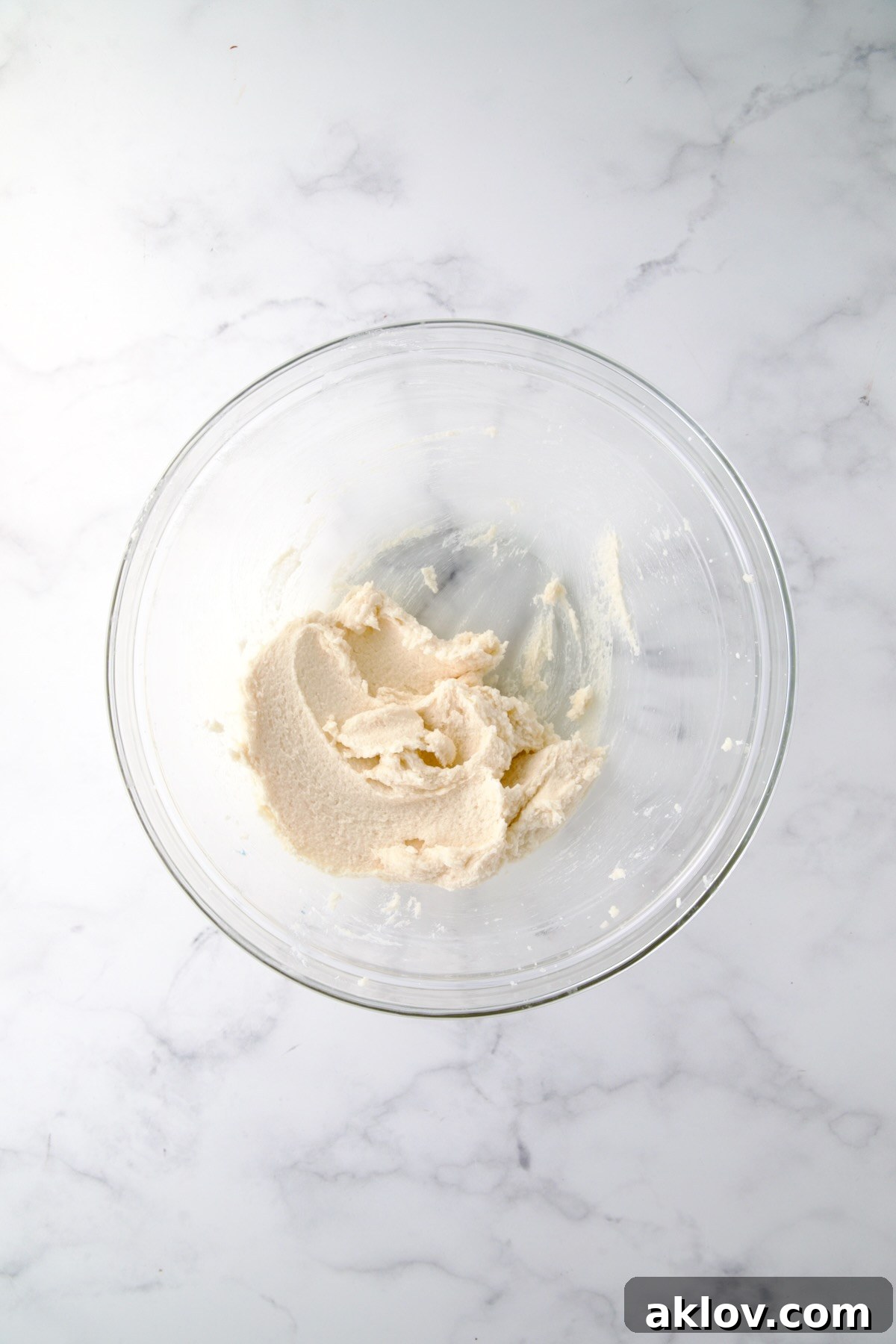Creamed butter and sugar in glass bowl.