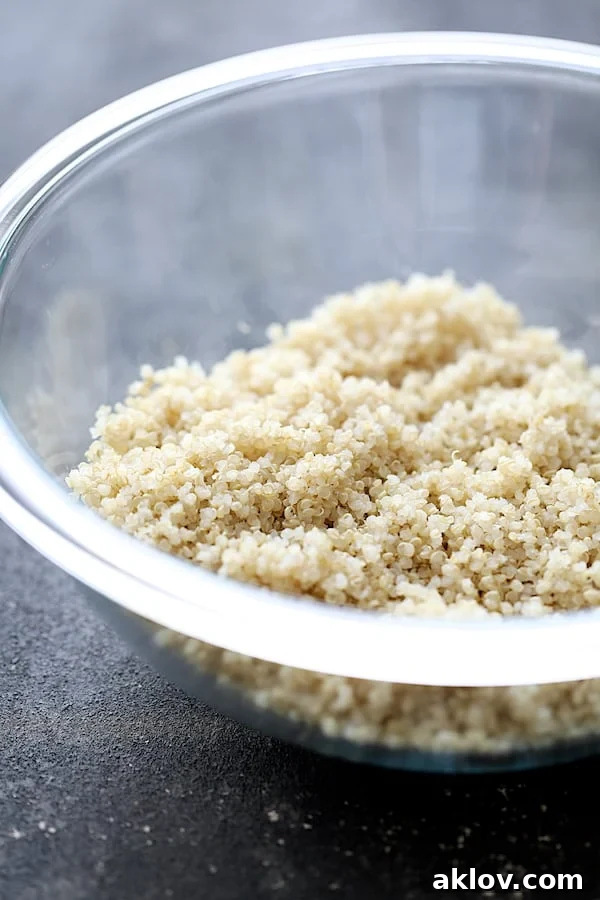 Photo of cooked quinoa in glass mixing bowl.