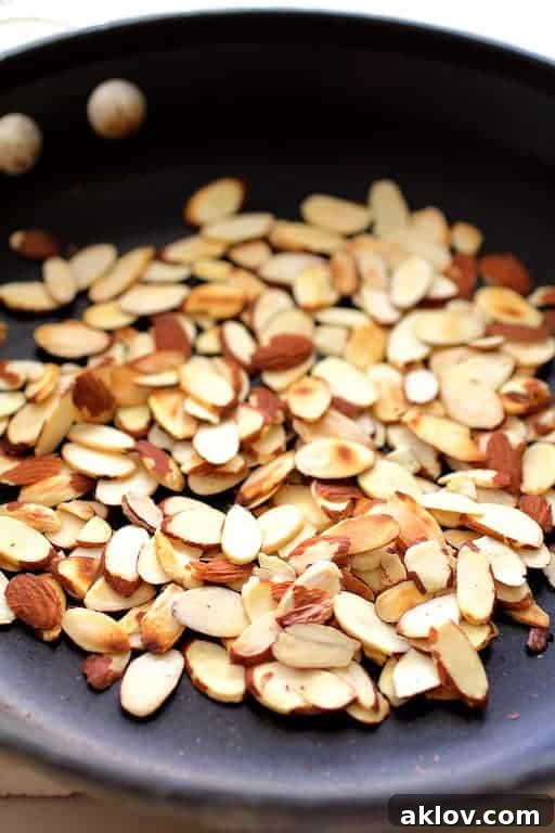 Photo of toasted almonds in nonstick skillet.