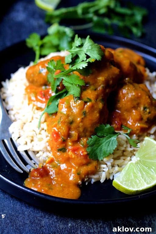 Close-up shot of meatballs over rice.