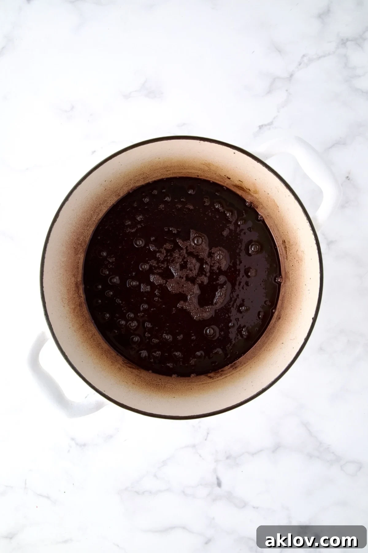 Red wine added to white Dutch oven after beef rolls are browned.