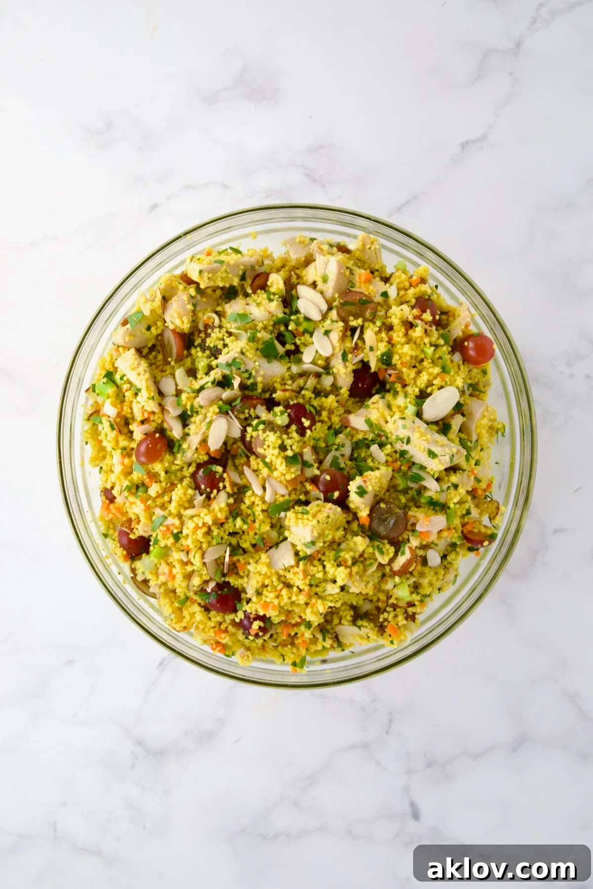 Ingredients for Chicken Couscous Salad in glass bowl after being combined.