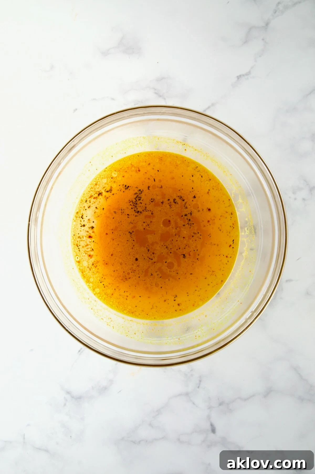 Water with seasoning in glass bowl for the couscous,