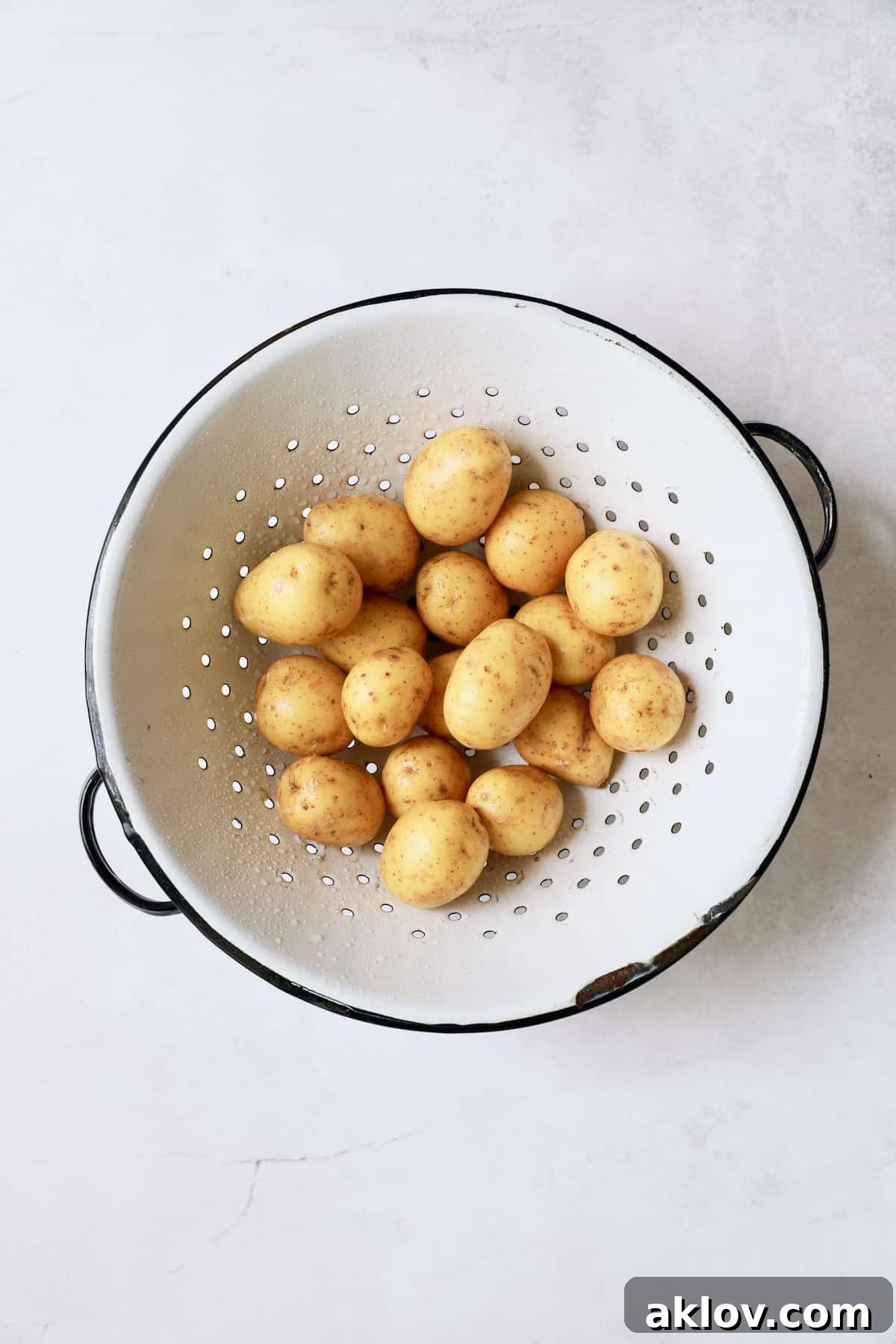 Photo of baby Yukon Gold potatoes in old white colander.