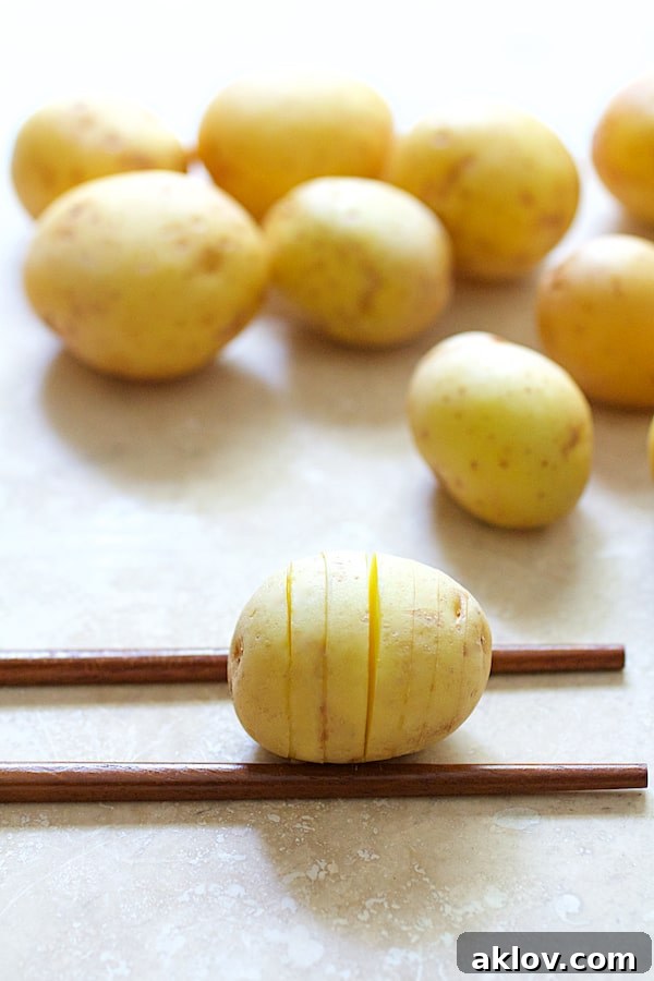 Photo of Yukon Gold potatoes on chopsticks after being hasselbacked.