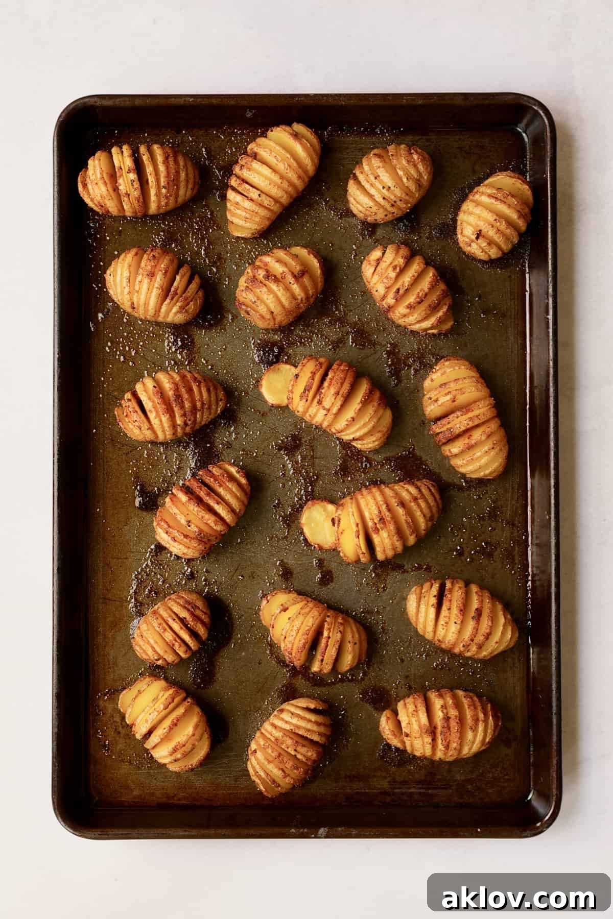 Photo of hasselbacked potatoes on baking sheet after being roasted.