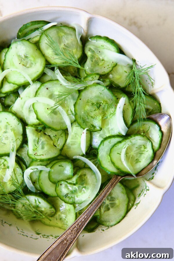 Cucumber Onion Salad in serving bowl with serving spoon.