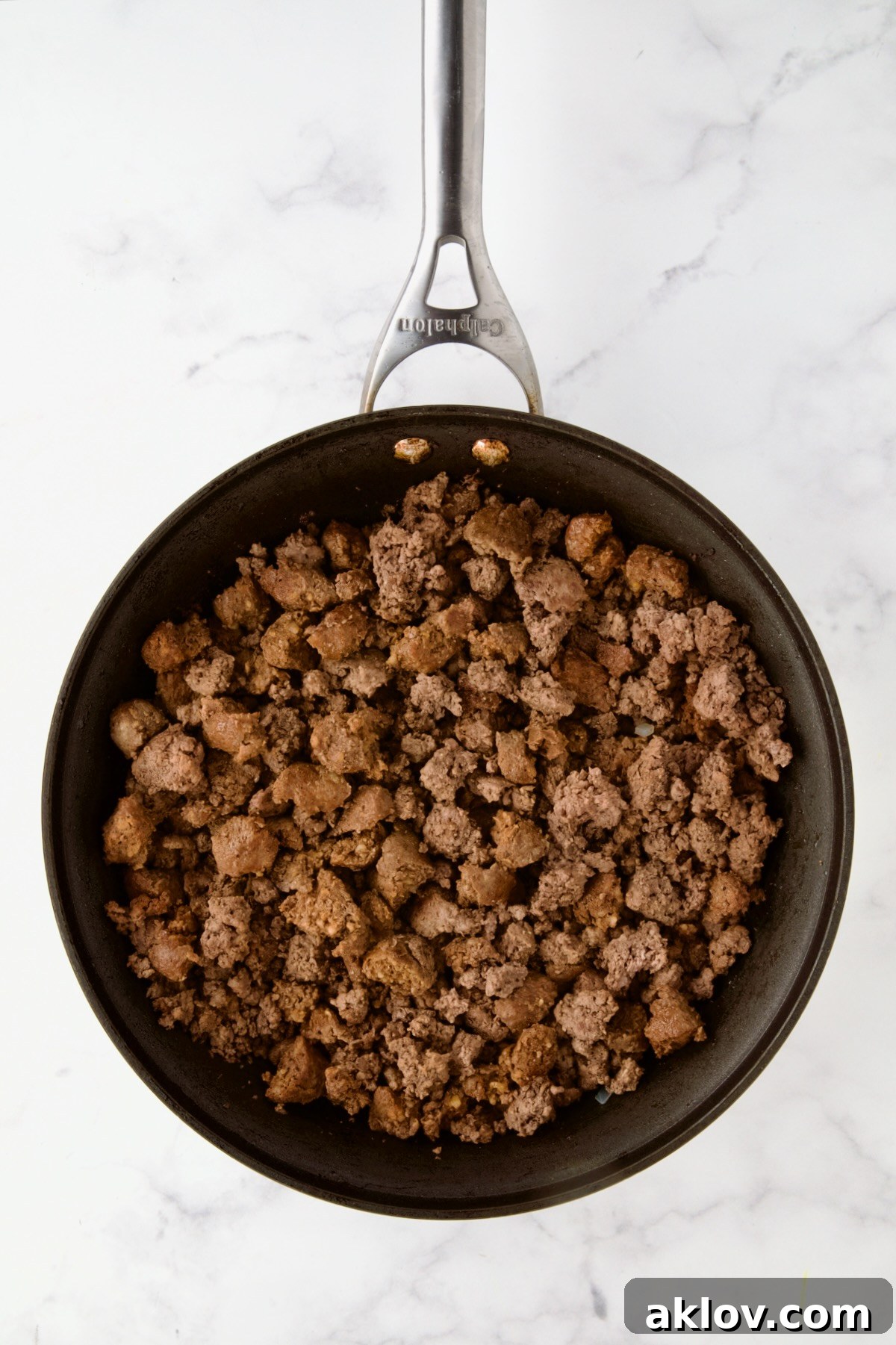 Browned ground beef and pork in nonstick skillet.
