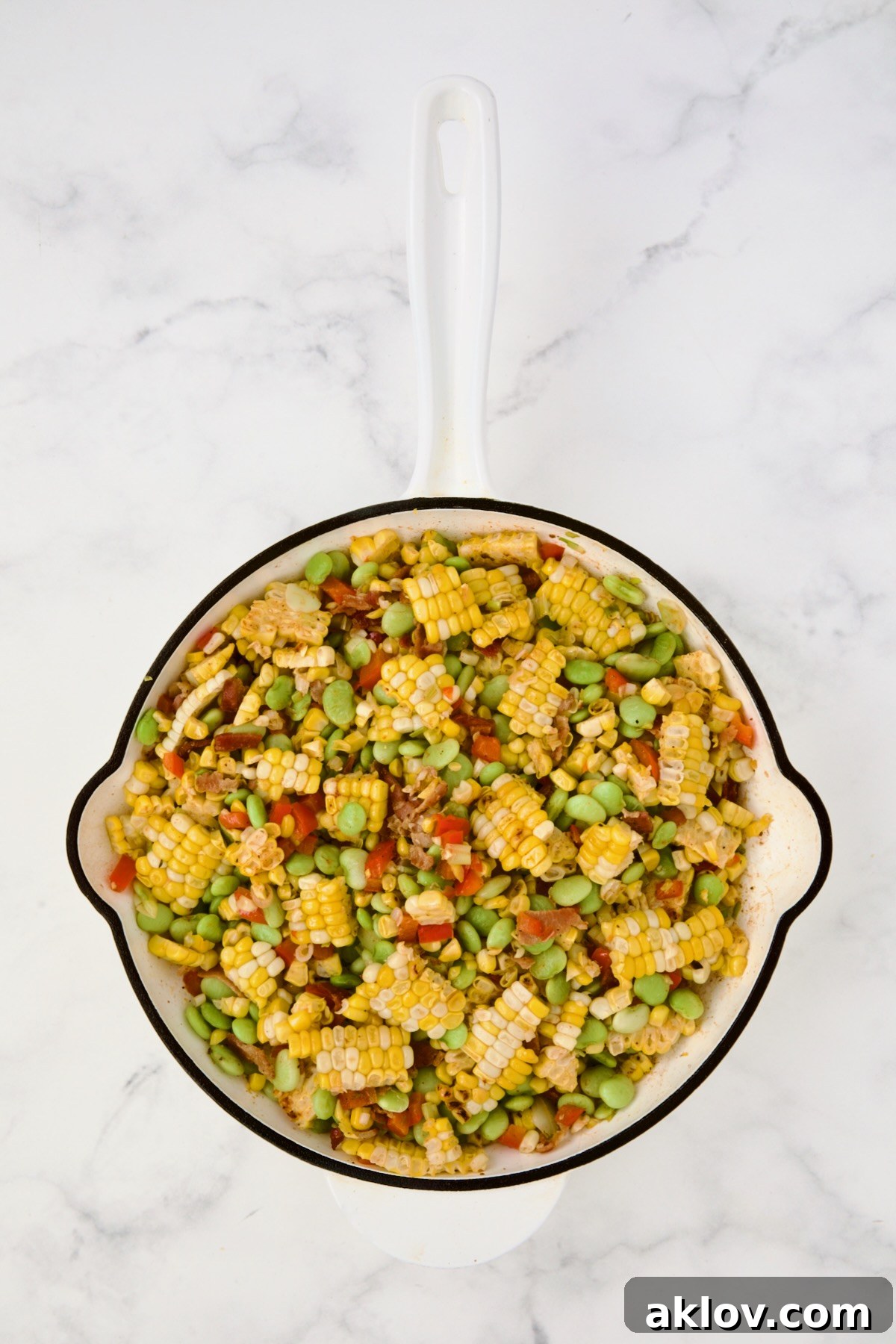 Succotash in white enamel cast iron skillet.