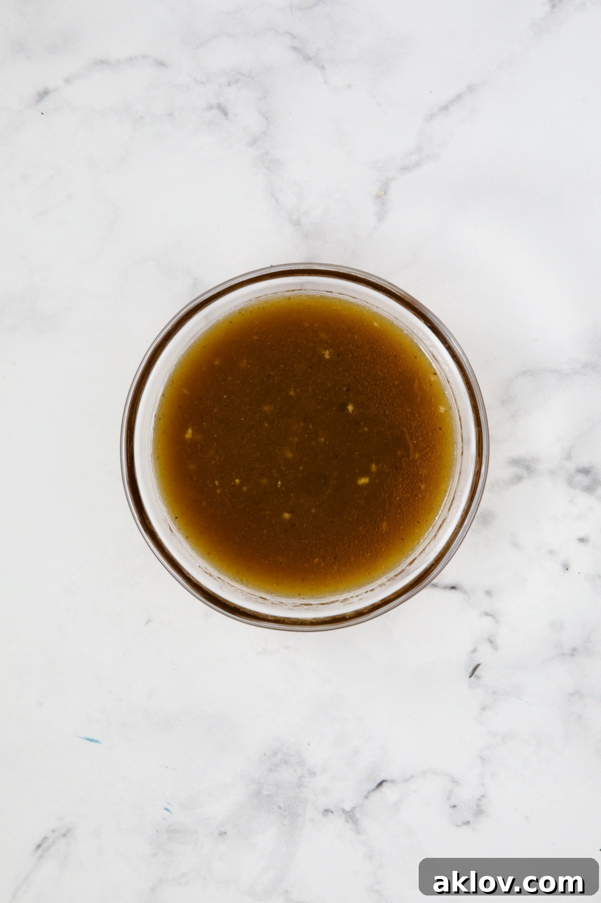 A small bowl of freshly whisked balsamic vinaigrette, showcasing its smooth, emulsified texture.