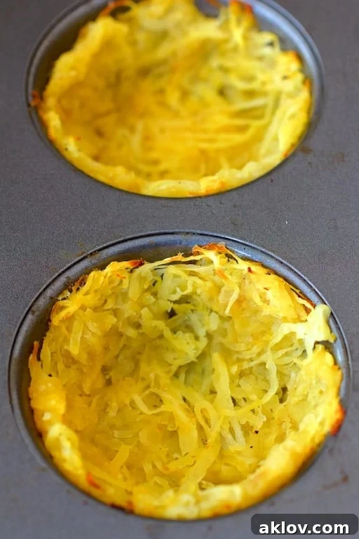 Grab-and-Go Savory Egg Tarts 5 Close-up photo of prepared spaghetti squash "crusts" inside a muffin pan, lightly baked and ready for filling.