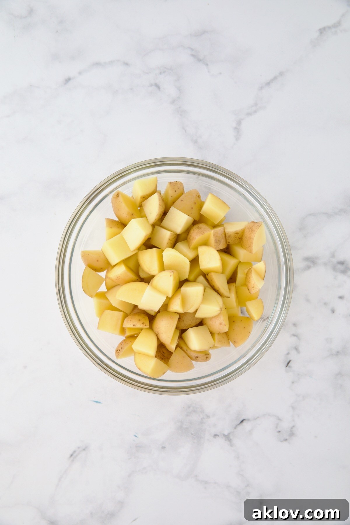 Cubed potatoes in glass bowl.