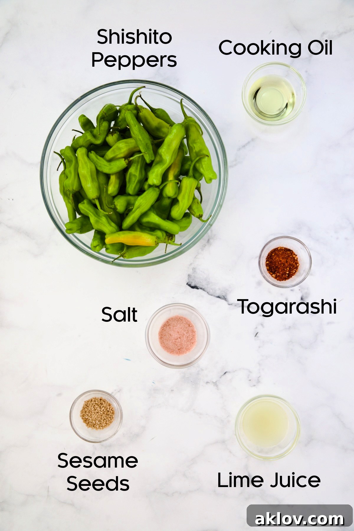 Ingredients for Blistered Shishito Peppers laid out in glass bowls, including fresh shishitos, oil, togarashi, and sesame seeds.