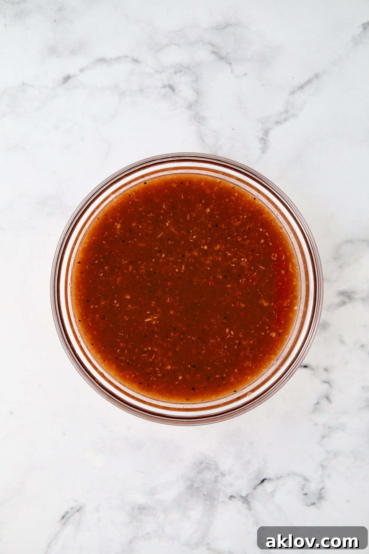 Bloody Mary marinade in glass bowl.