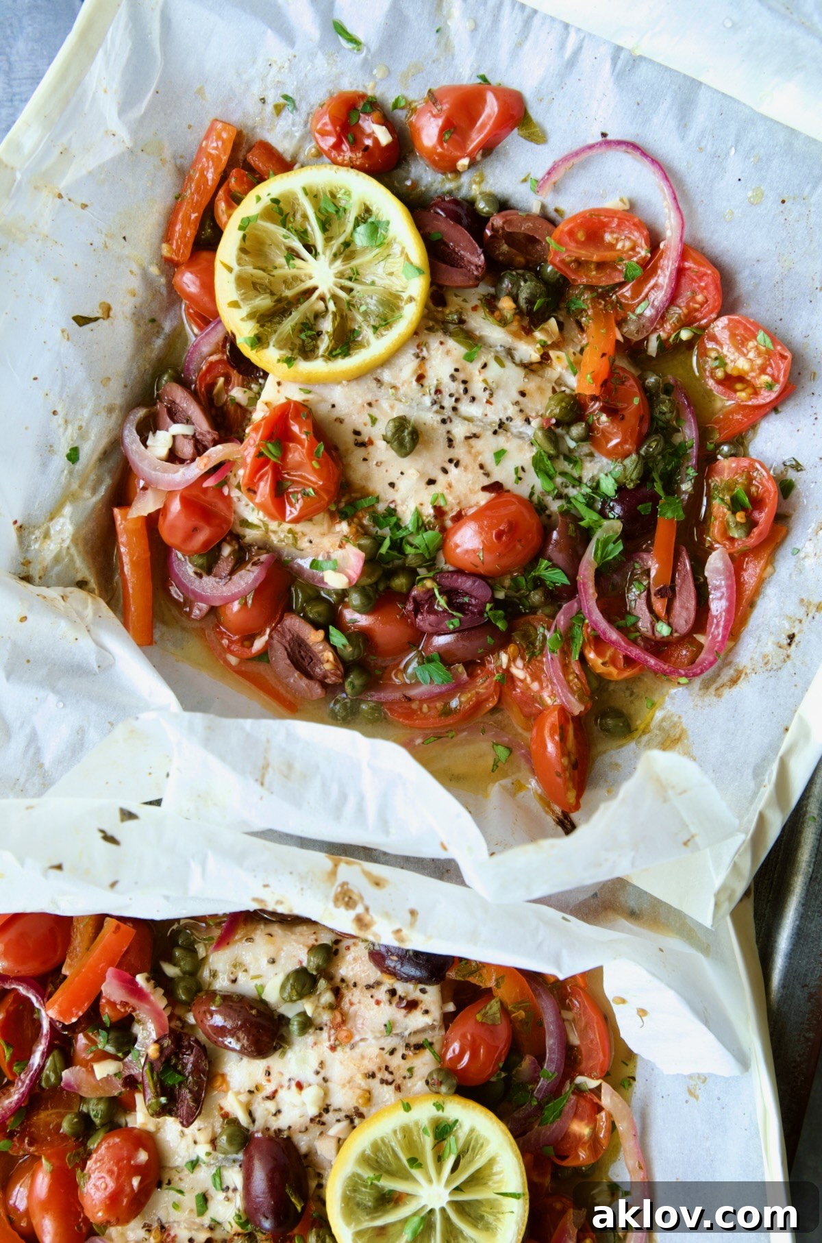 Flavorful Mediterranean Fish Parcels 13 Parchment paper packages opened to reveal baked fish.