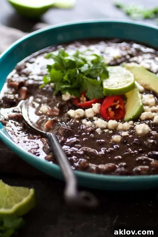 Hearty Slow Cooker Black Bean and Ham Soup 4 Close-up photo of Slow Cooker Black Bean Soup with Ham in blue bowl.