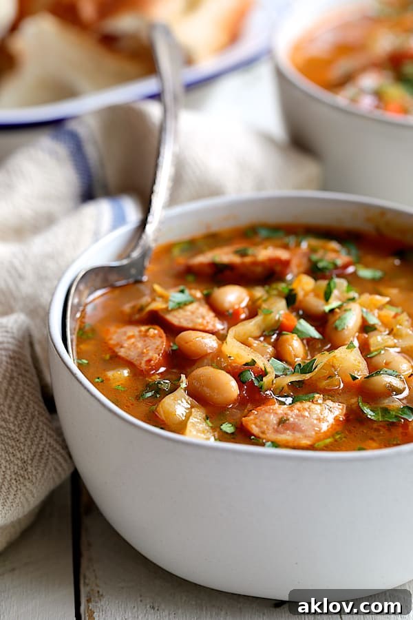 Smoky Kielbasa and Cabbage Stew with White Beans 6 A close-up view of a single serving of Farmhouse Cabbage Soup with Cannellini Beans and Kielbasa, showcasing its hearty ingredients and inviting texture.