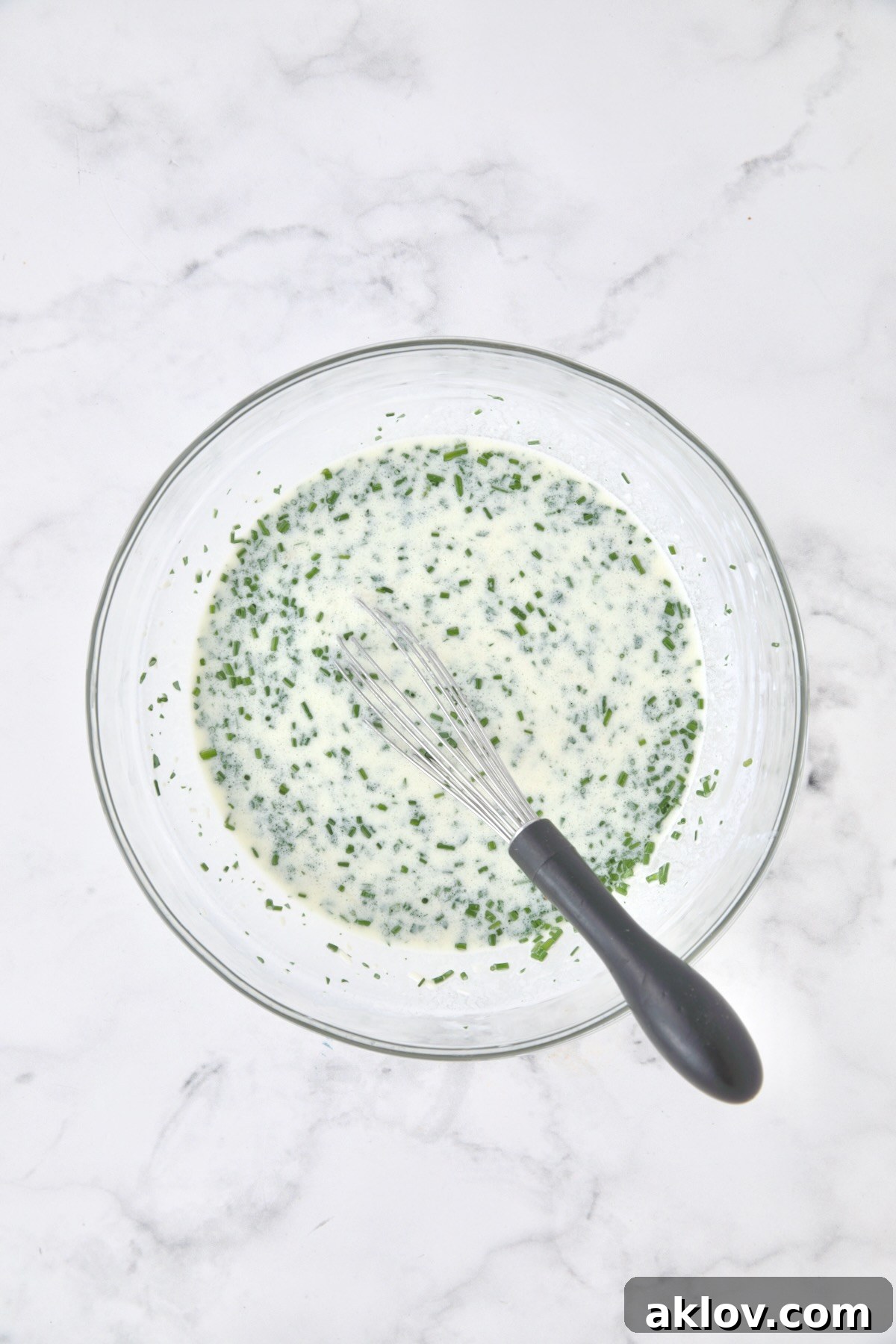 Wet ingredients for bread in glass bowl.