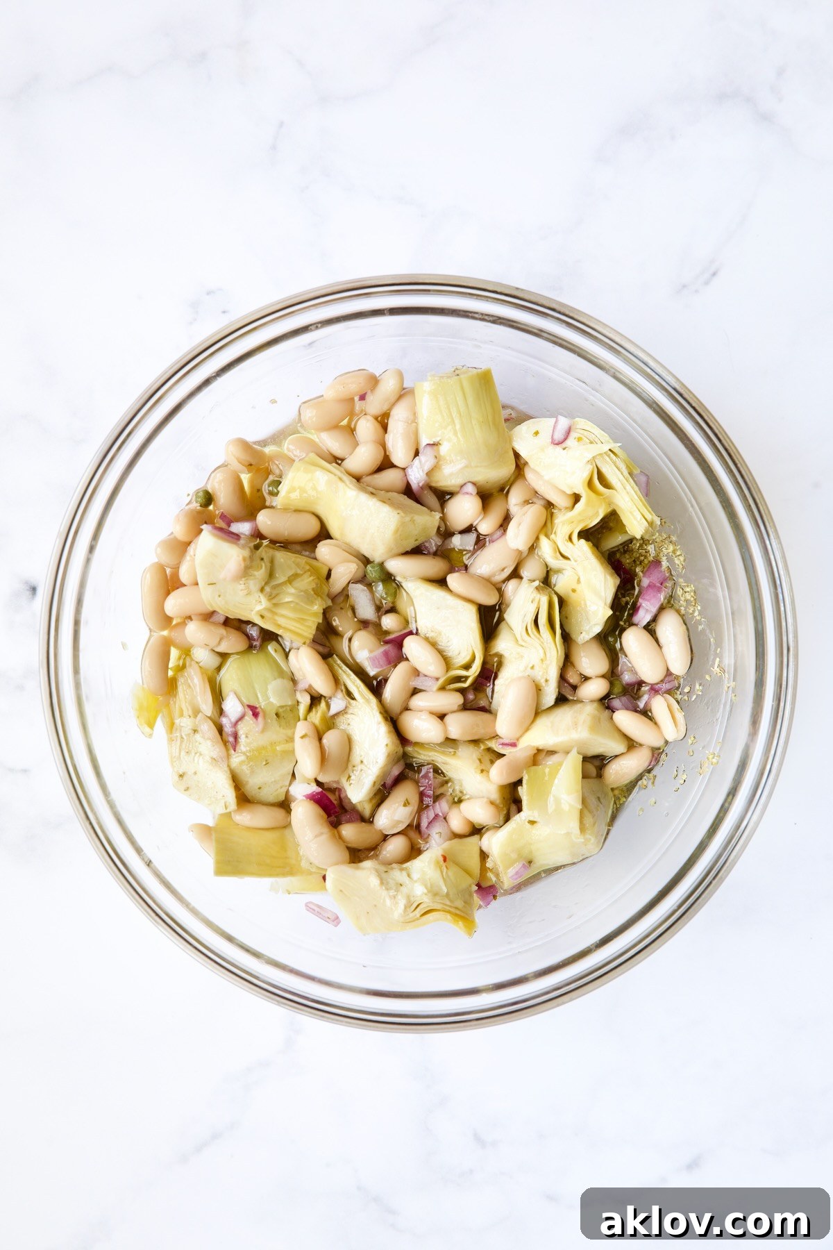 Artichokes and beans in glass bowl.