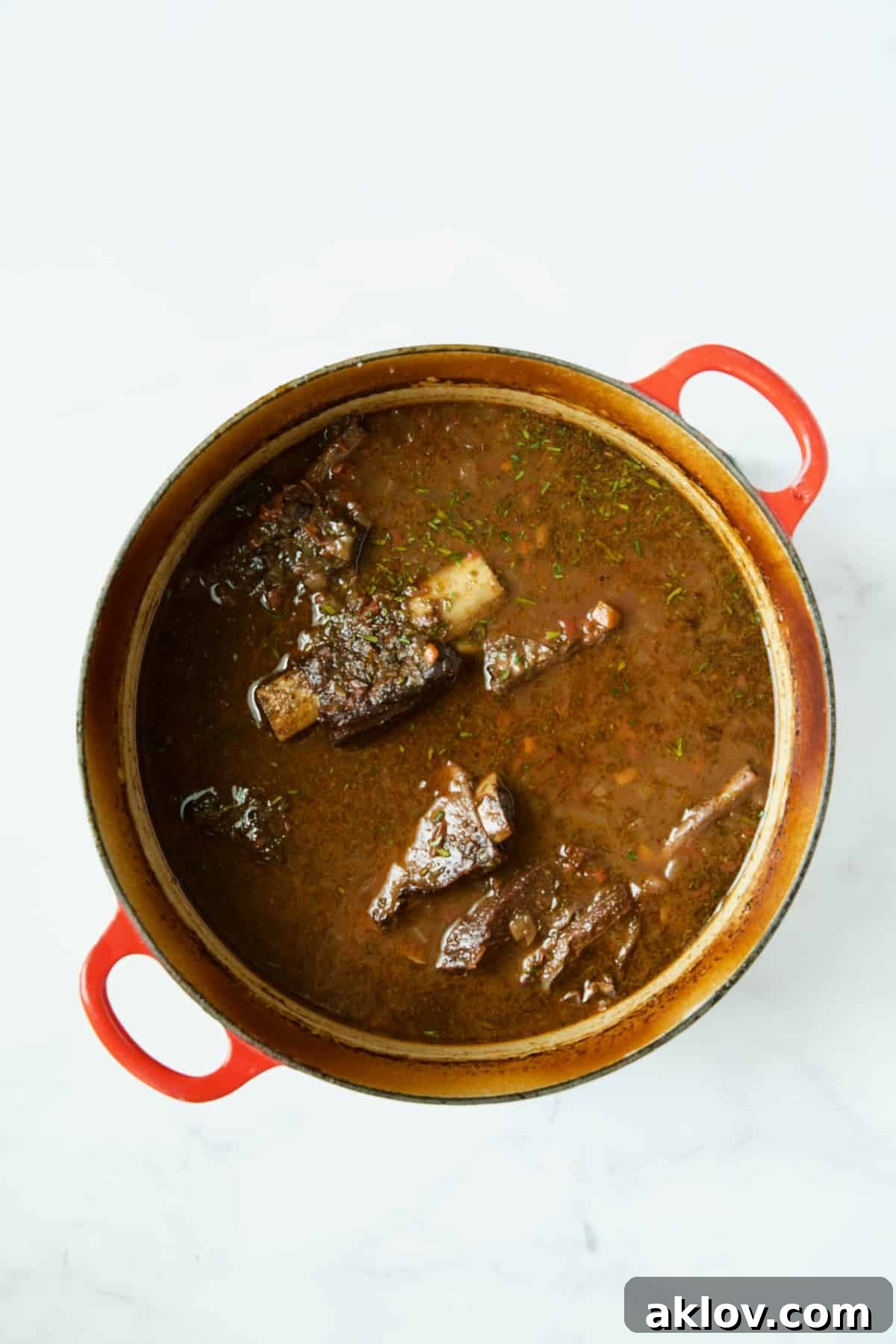 Perfectly braised beef short ribs, tender and glistening, after being removed from the oven.