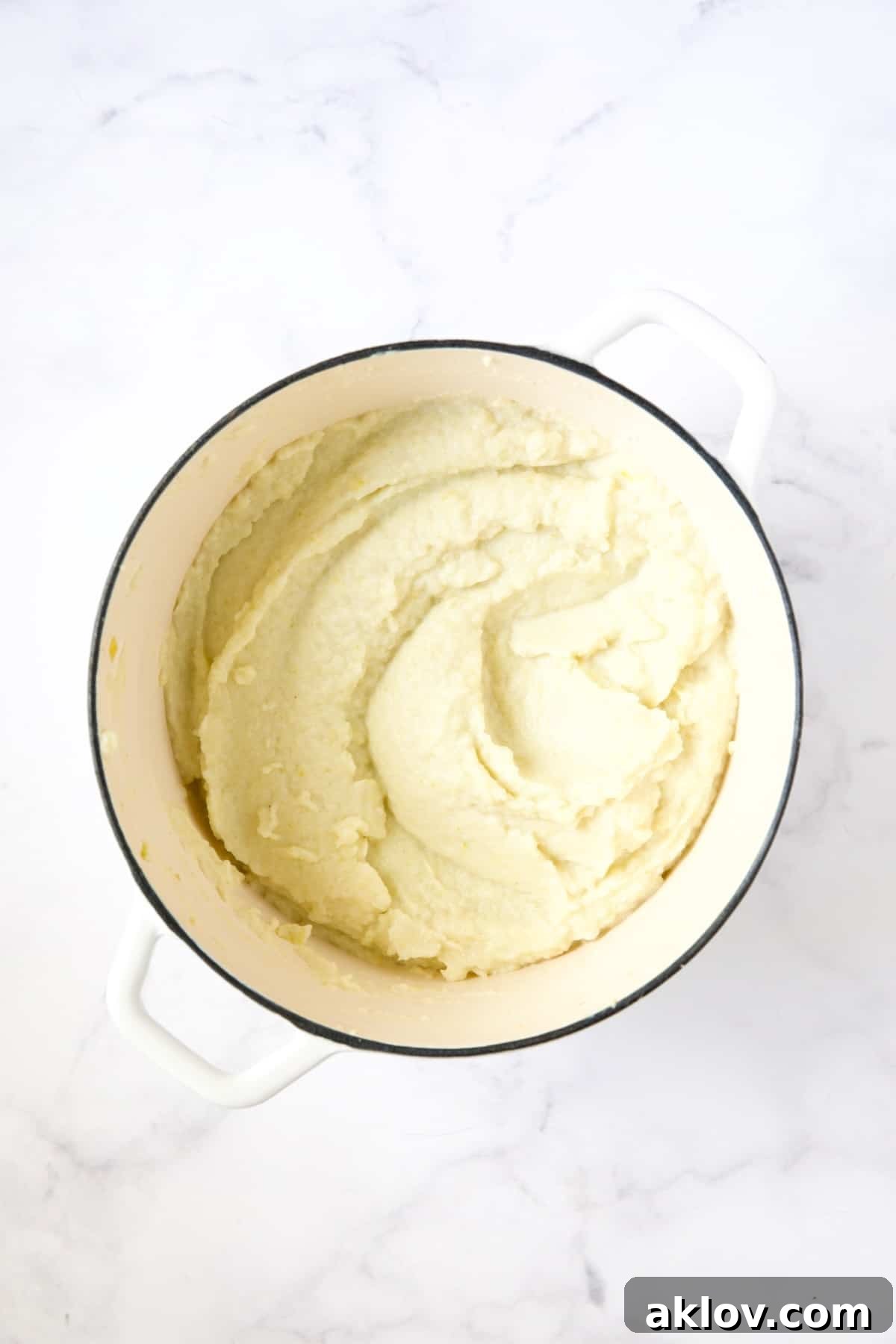 Smooth and creamy Cauliflower Leek Puree in a white enamel Dutch oven.