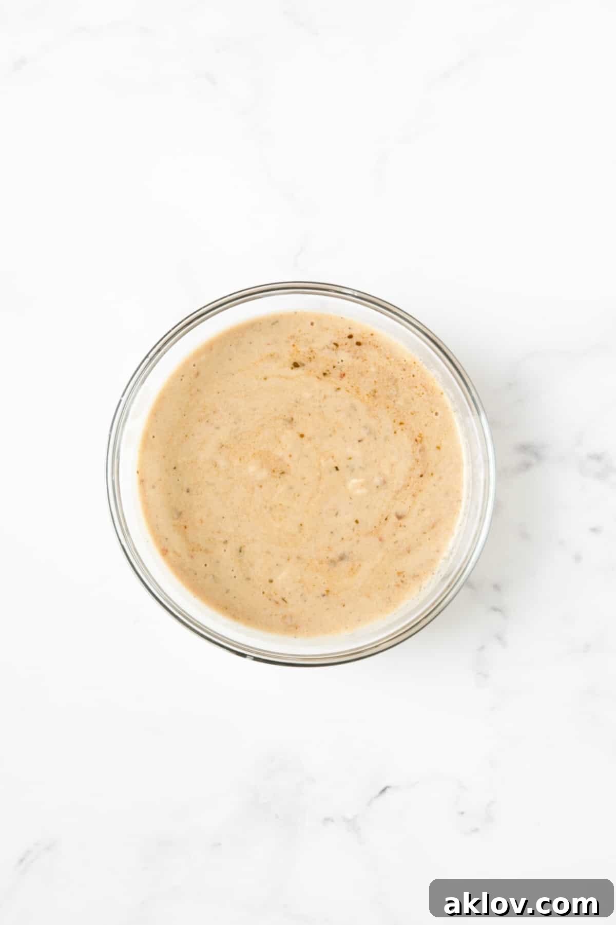 A smooth slurry of braising liquid and flour, prepared for thickening.