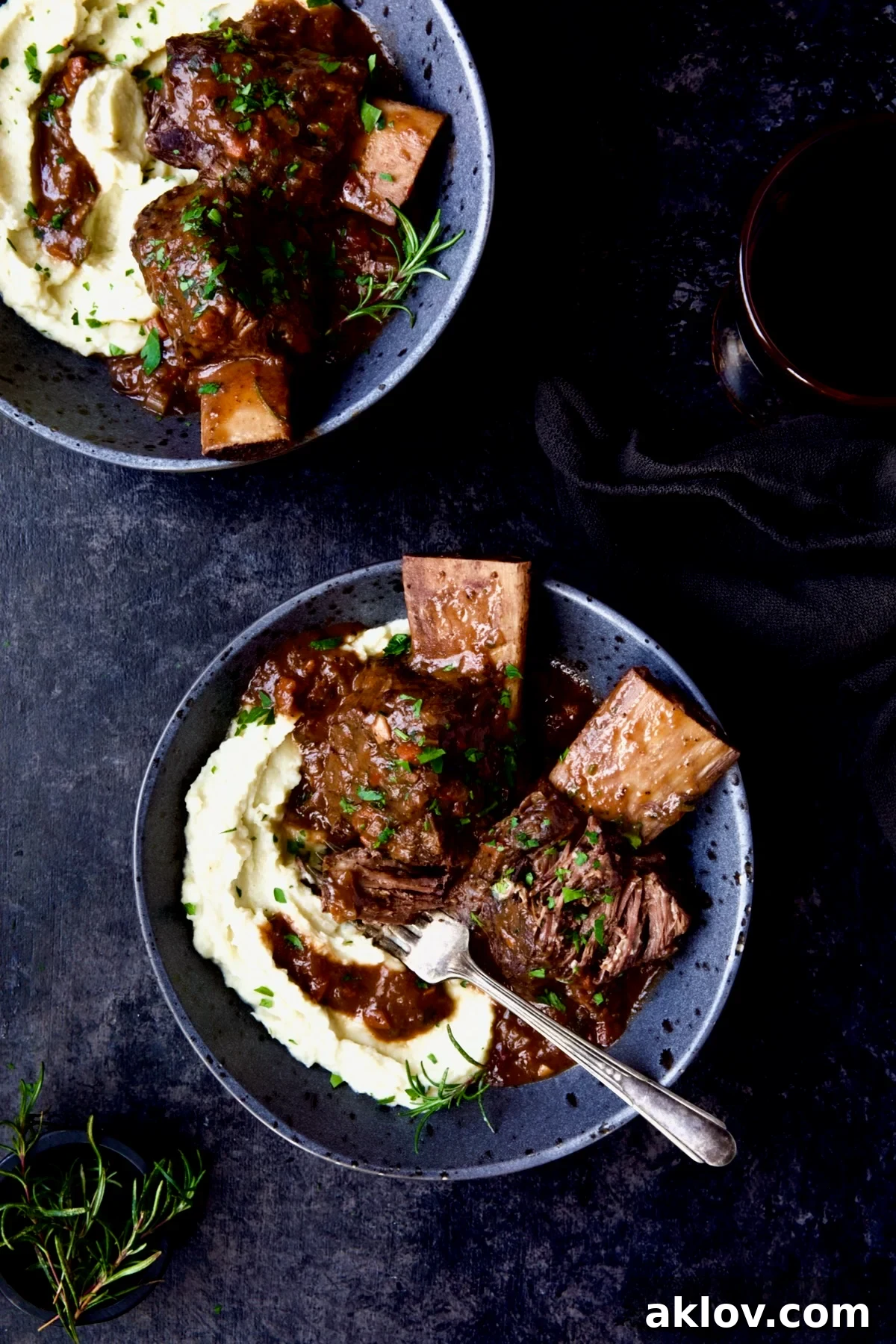 Two enticing bowls of Braised Beef Short Ribs with Cauliflower Leek Puree, perfectly presented for a comforting meal.