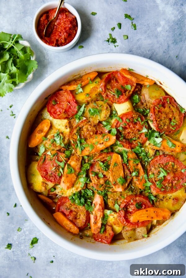 Moroccan Potato Tagine in round white baking dish, rich with spices and vibrant color.