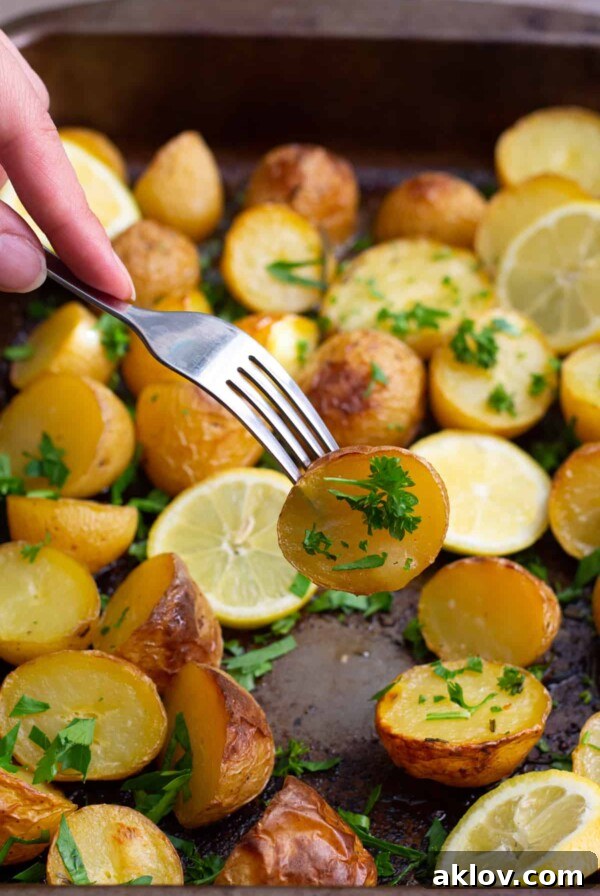Golden-brown Greek potatoes, infused with lemon, garlic, and herbs, showcasing their crispy exterior.