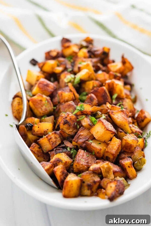 Crispy Skillet Fried Breakfast Potatoes in white oval bowl, reminiscent of diner-style home fries.