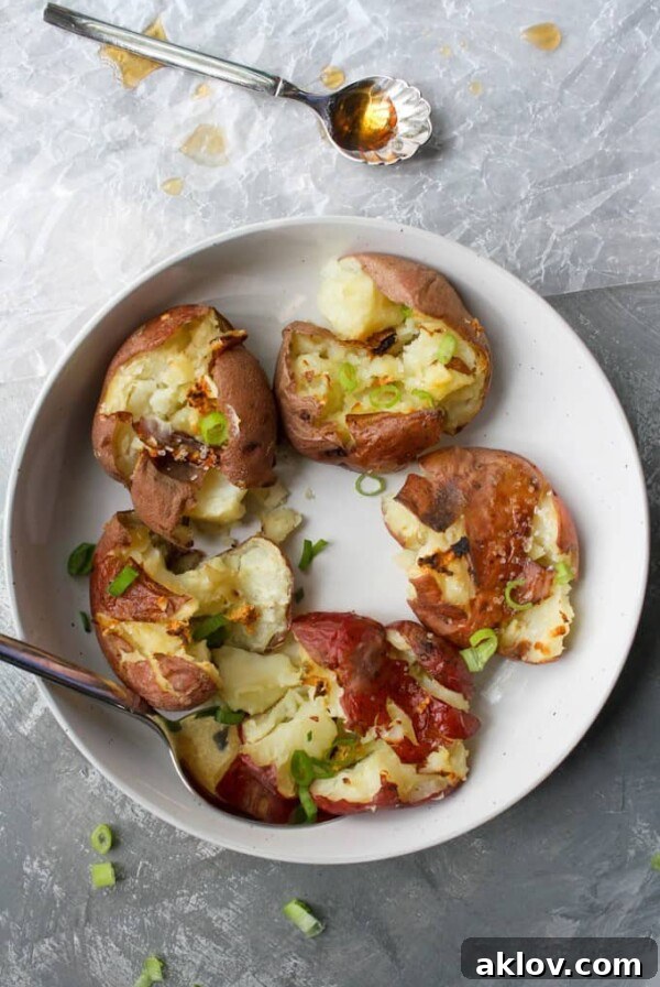 Five Salt and Vinegar Smashed Potatoes in white serving bowl, offering a tangy and crispy texture.