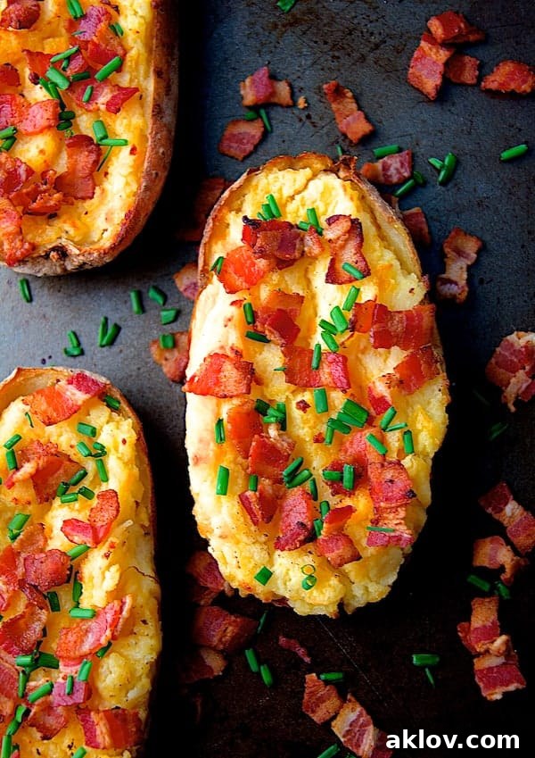 Cheddar and Bacon Twice Baked Potatoes on baking sheet, a classic comforting side.