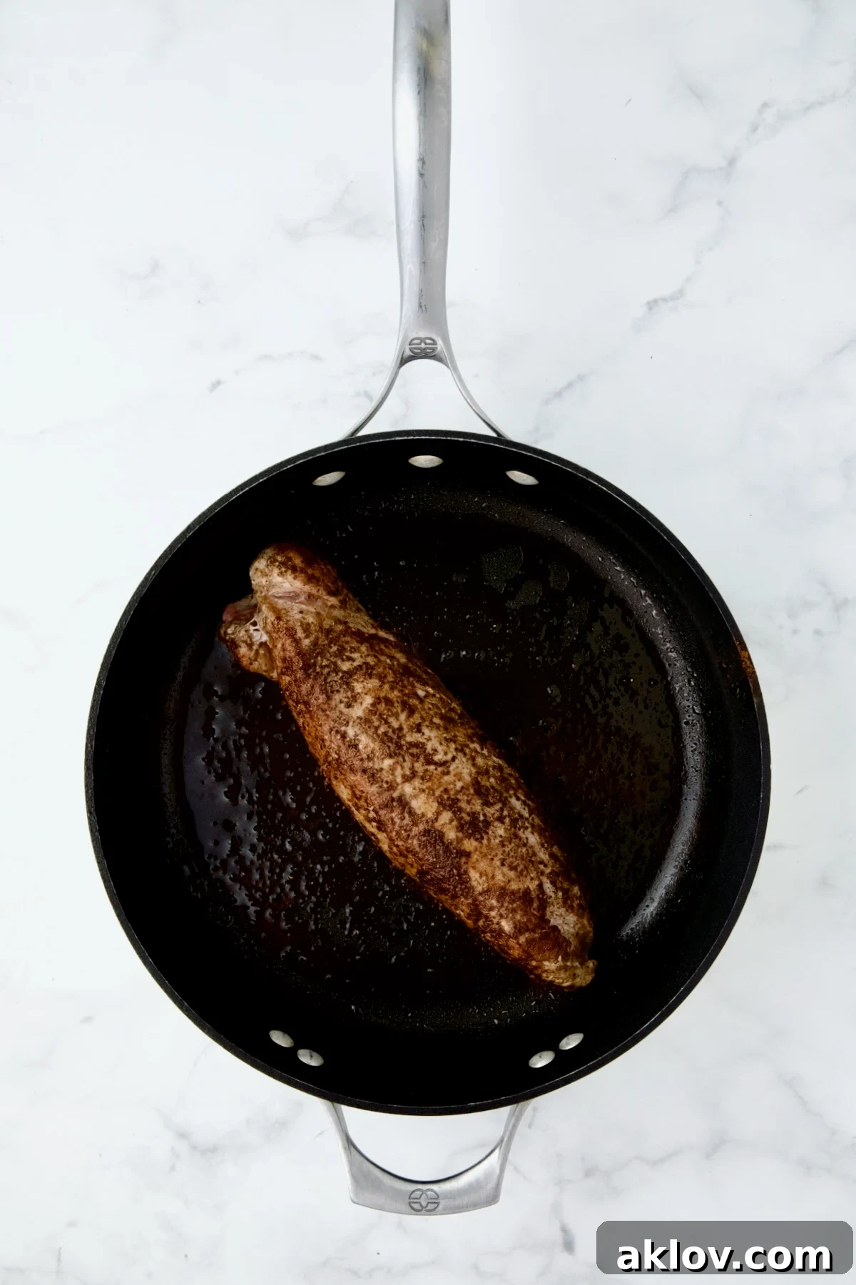 Seasoned and browned pork tenderloin in nonstick cast iron skillet.