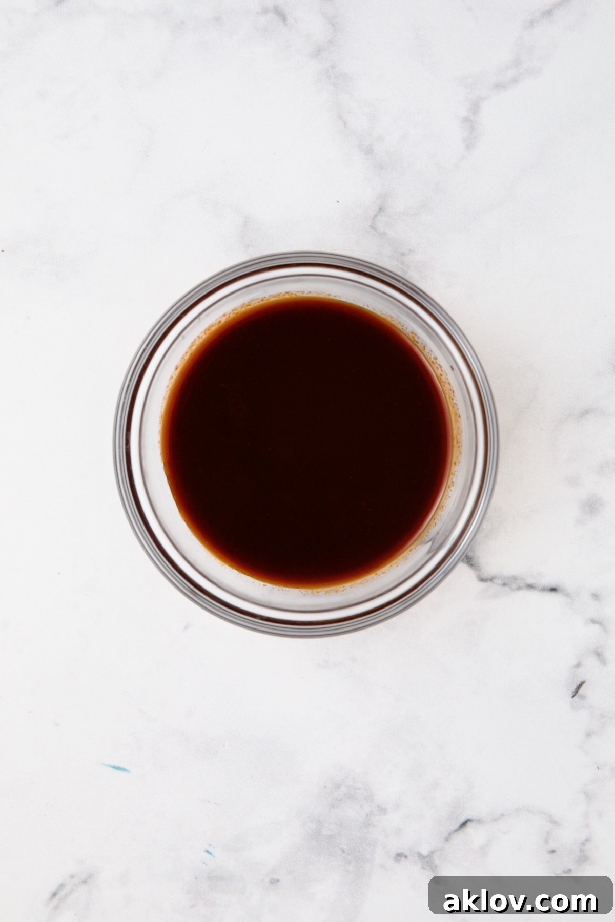 Maple, bacon and gochujang glaze in glass bowl.