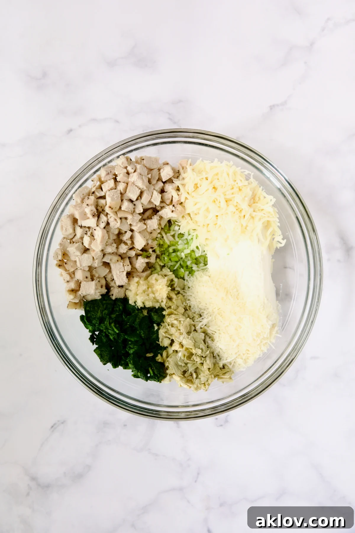 Filling ingredients for cannelloni in glass bowl before being combined.