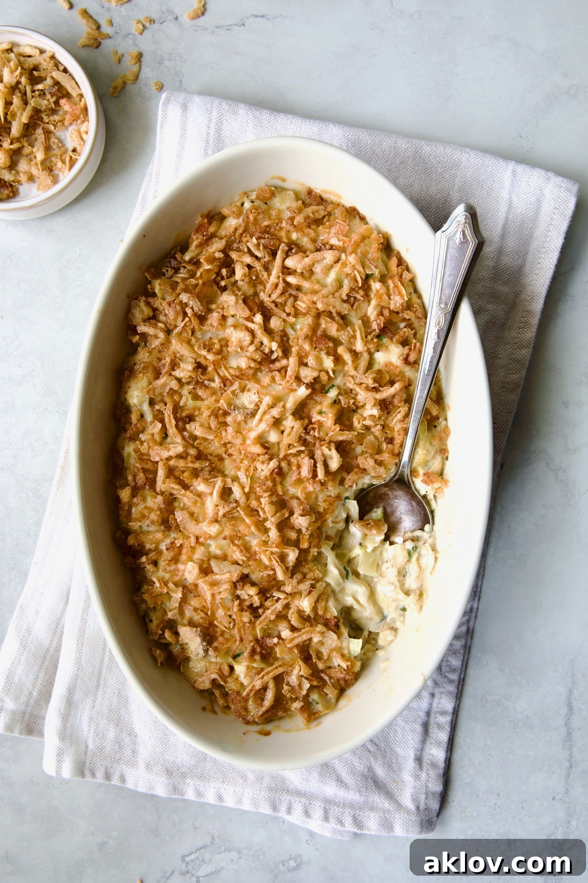 Another beautiful shot of the Creamed Cabbage Casserole, showcasing its rich texture and appetizing topping, served in a white oval dish.