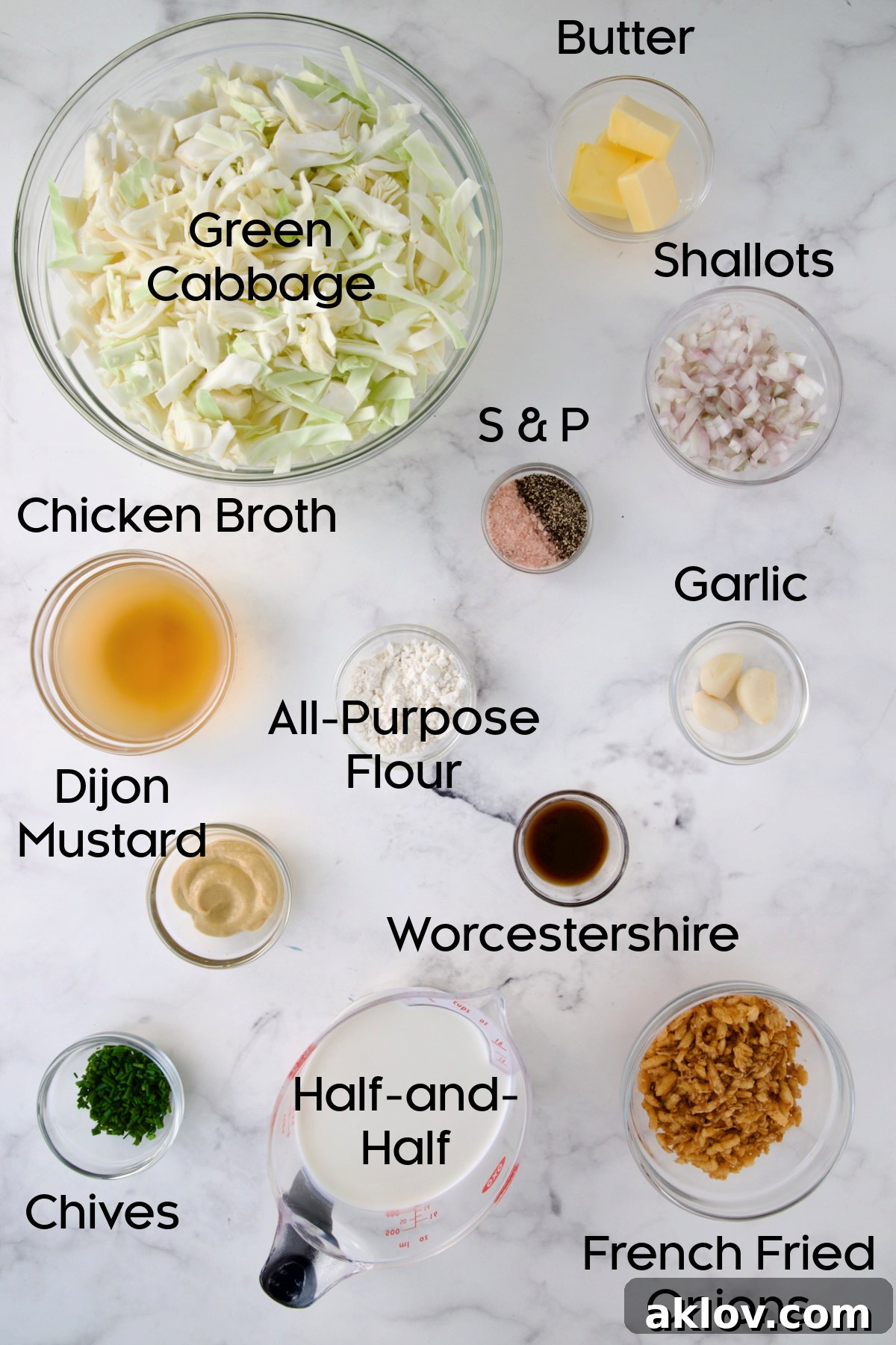 Various ingredients for Creamed Cabbage Casserole neatly arranged in glass bowls on a kitchen counter, showcasing fresh cabbage, shallots, butter, and seasonings.