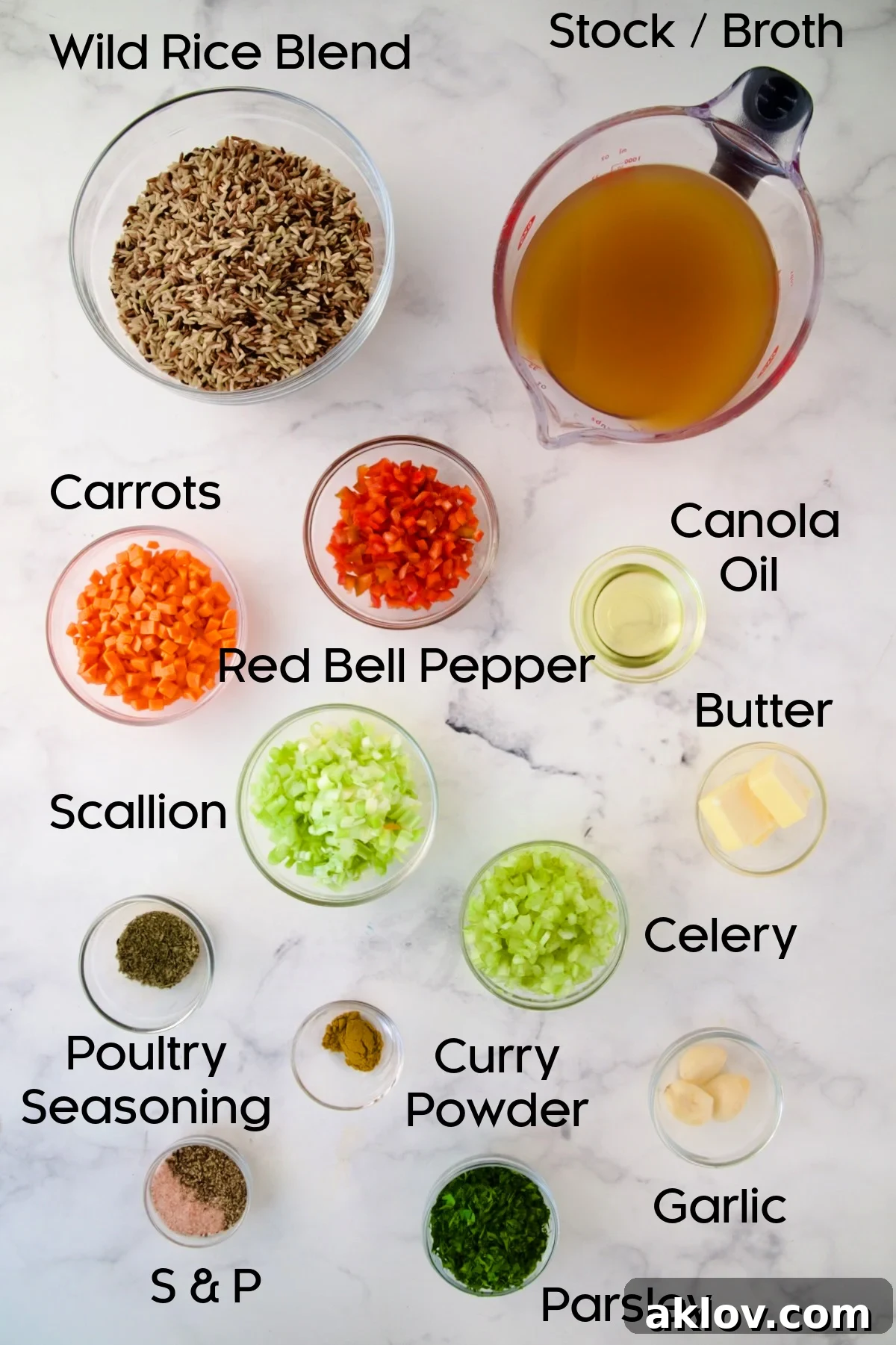 Various ingredients for Wild Rice Pilaf, neatly arranged in glass bowls on a rustic wooden surface.