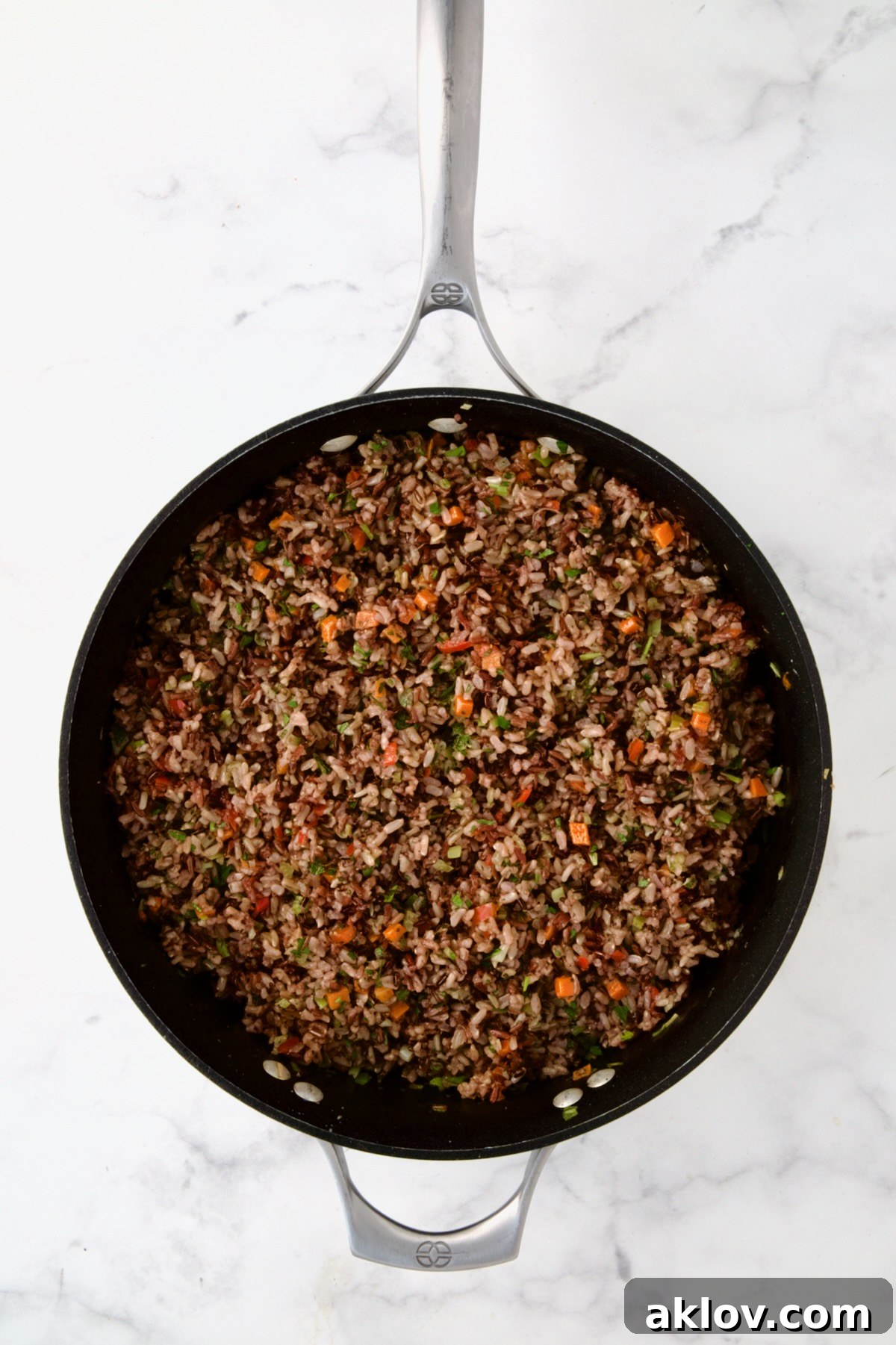 The fully cooked Wild Rice Pilaf, a harmonious blend of grains and vegetables, in a nonstick skillet, ready for final seasoning.