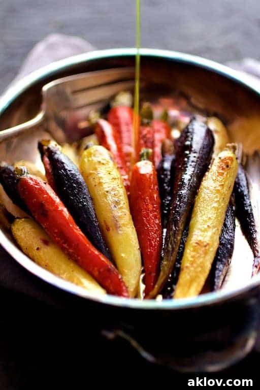 Photo of Curry Roasted Carrots with Honey Browned Butter being drizzled with butter.