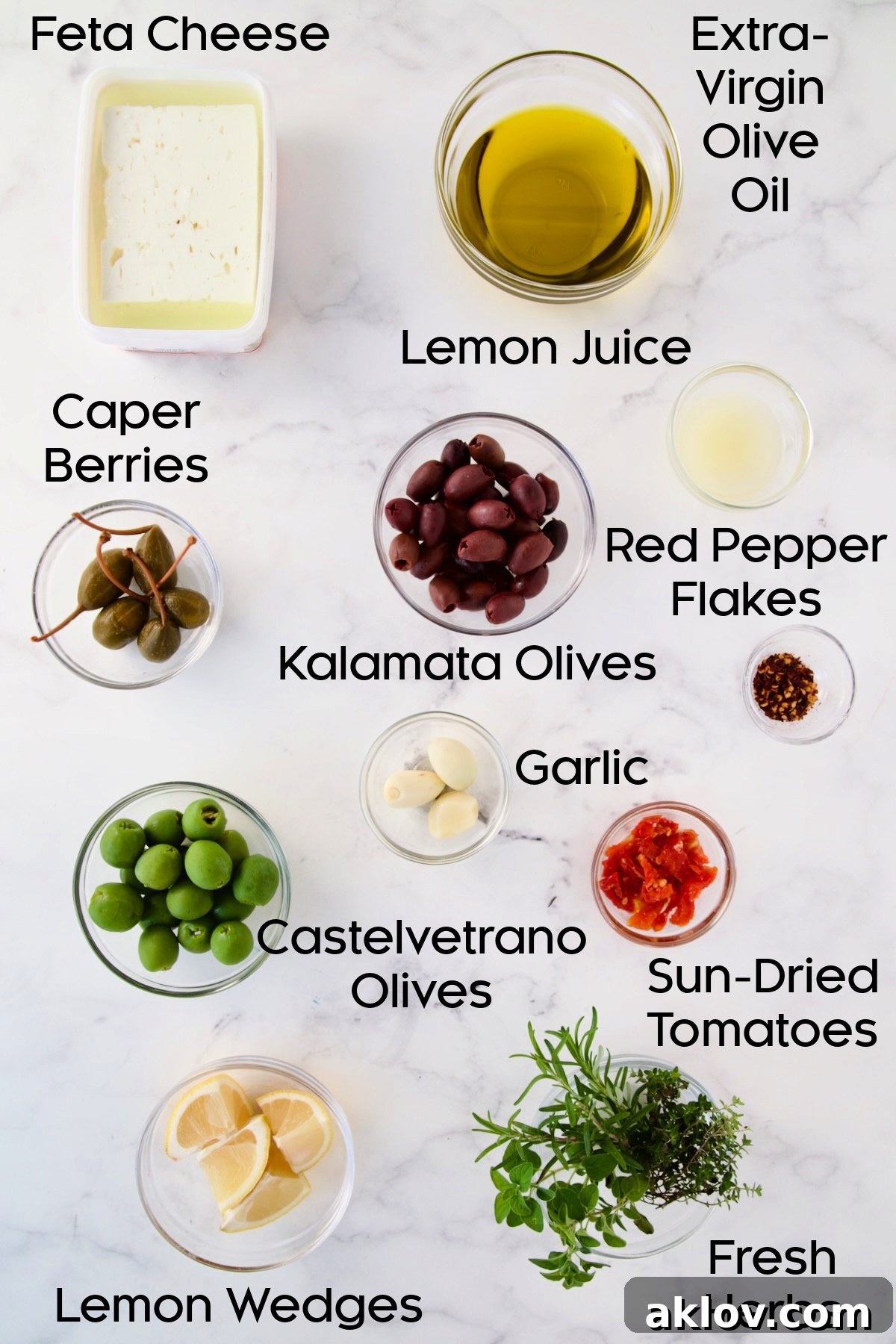 Ingredients for Baked Feta Cheese and Olives in glass bowls.