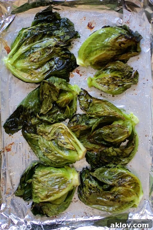 Beautifully roasted cabbage sprouts, golden and slightly caramelized, on a baking sheet after cooking.
