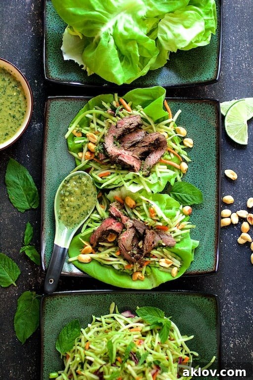 Another enticing photo of Thai Beef Lettuce Wraps with Mint Dressing and Vegetable Slaw served on green square plates.