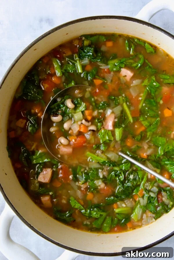 Black-Eyed Pea Soup in white Dutch oven with soup ladle.