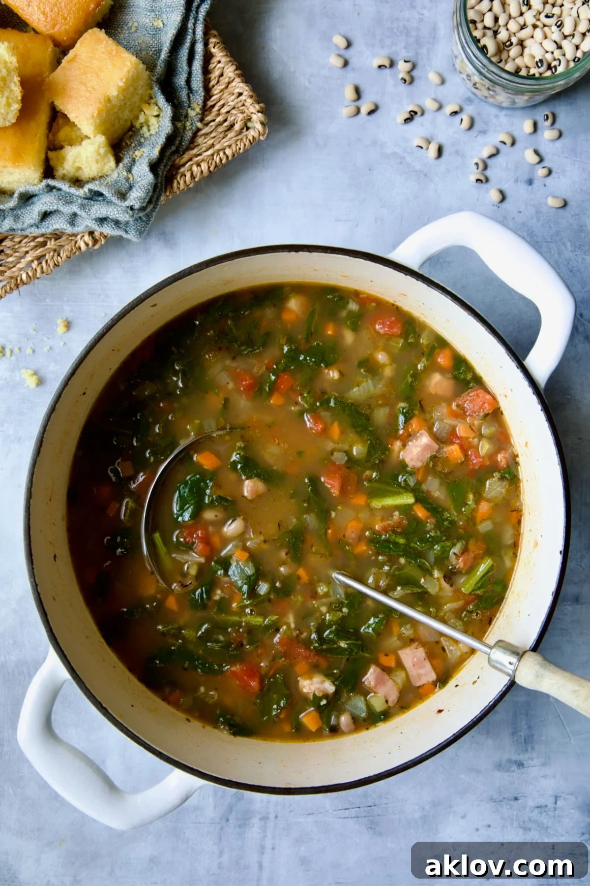 Black-Eyed Pea Soup in white Dutch oven with soup ladle.