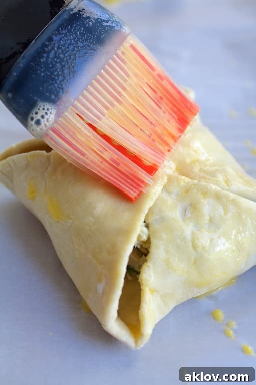 Photo of puff pastry parcel being brushed with egg.