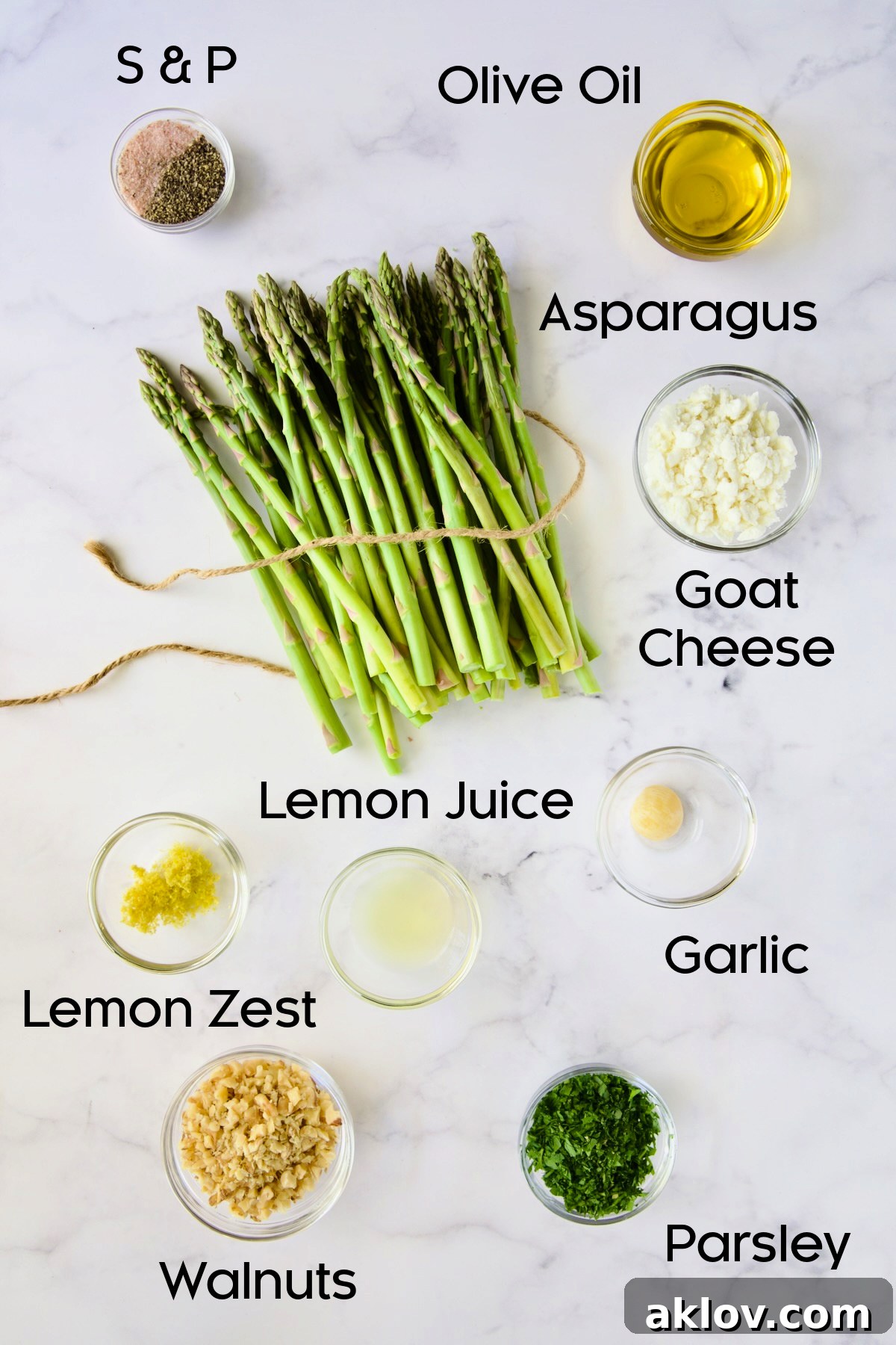 All the fresh ingredients for Roasted Asparagus with Walnut Lemon Gremolata and Goat Cheese, neatly arranged in glass bowls.