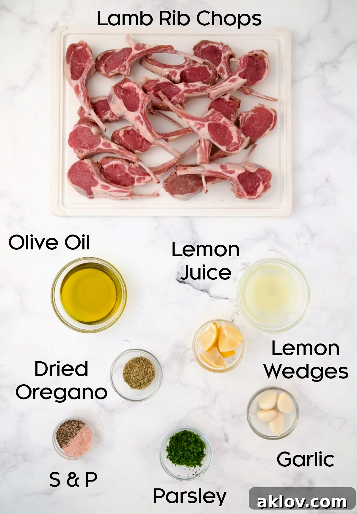 Fresh ingredients for Greek lamb chops, including lamb, lemons, garlic, olive oil, and oregano.