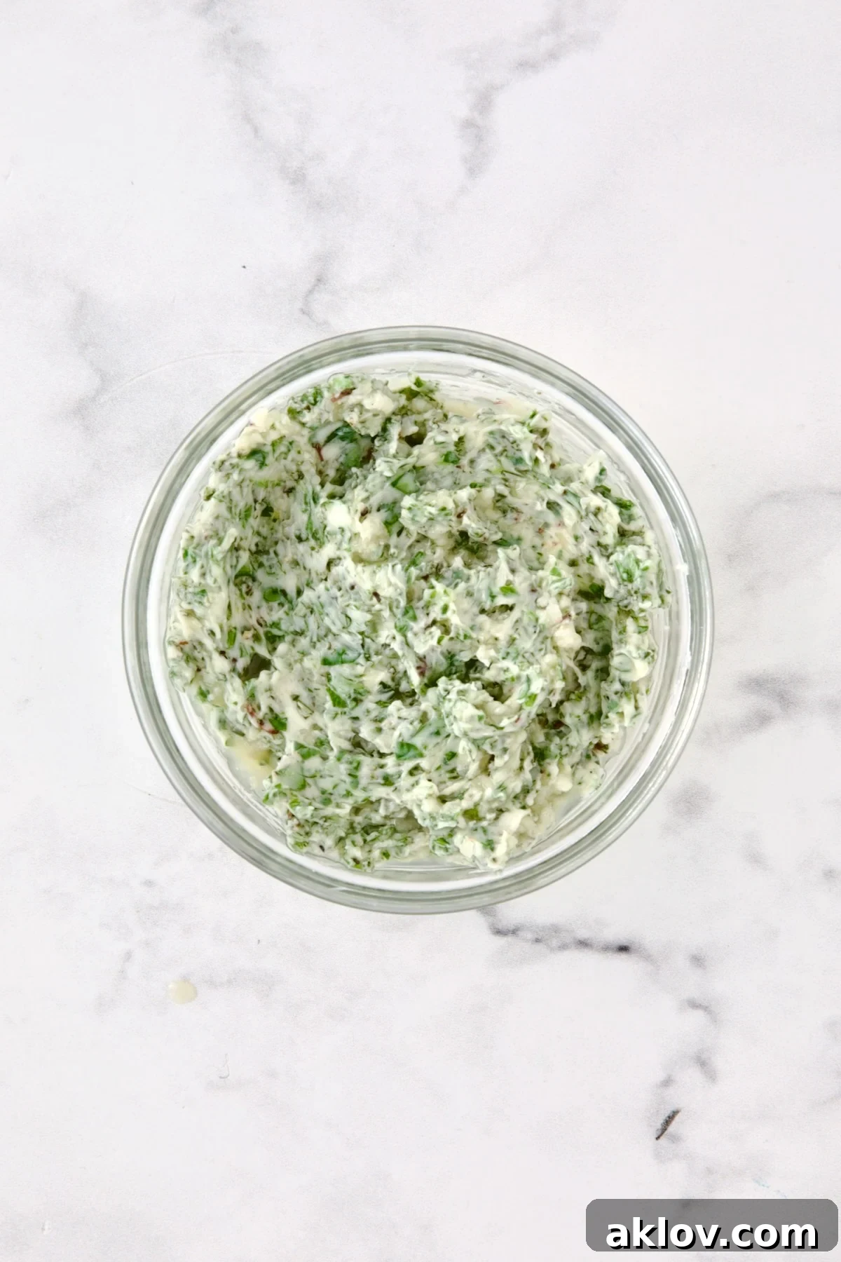 Herb butter in glass bowl.