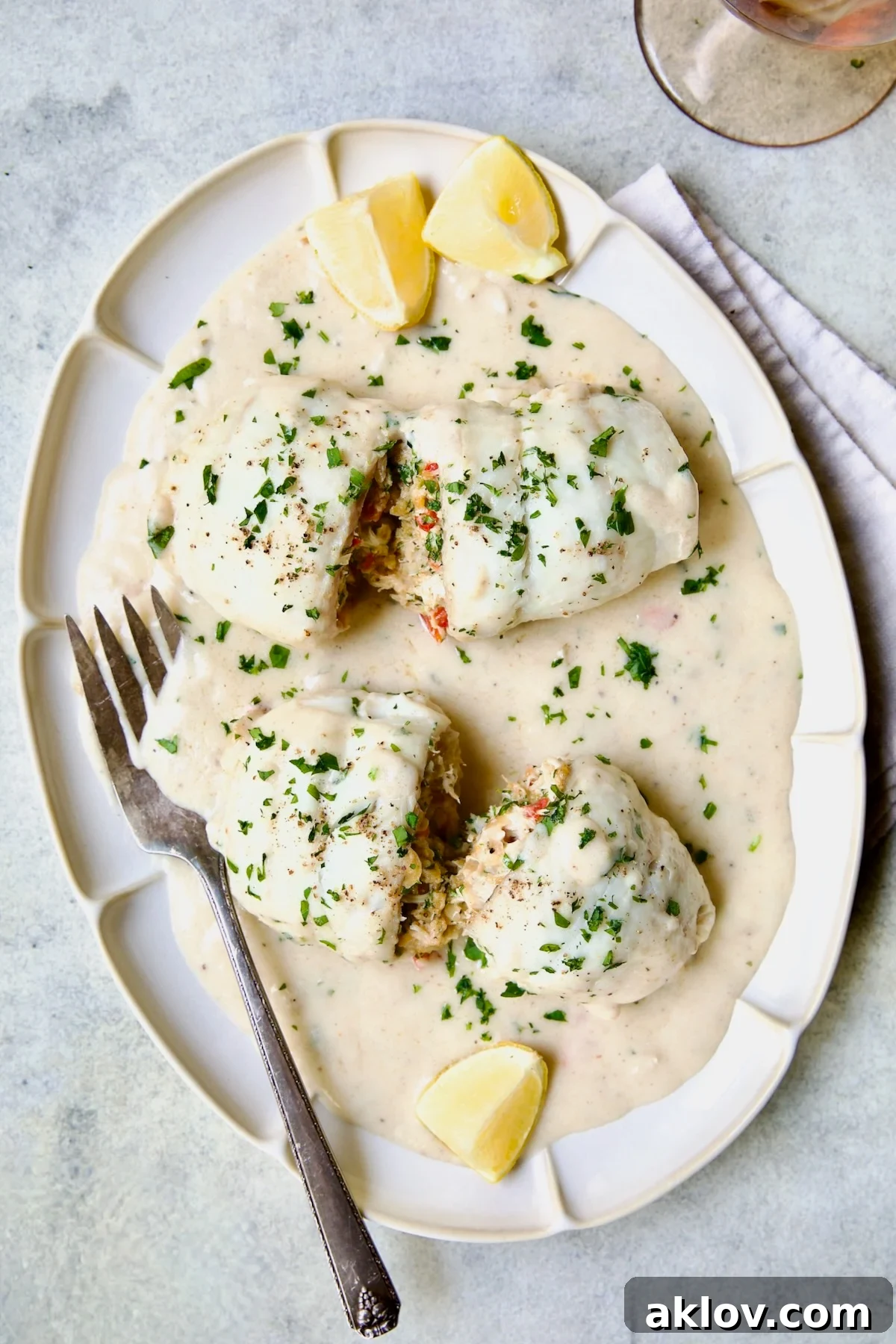 Two servings of Crab-Stuffed Flounder on oval platter, perfectly golden and glistening.